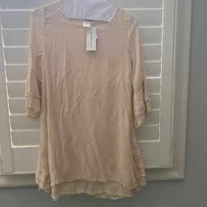 Never worn… Ivory tunic top with tiny pom pom details